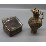 Metal mounted squat lidded ewer with shaped handle and cast detail throughout, together with a slope