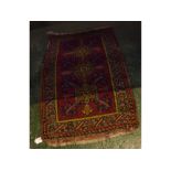 Small prayer rug decorated with a rust field with three lozenge centre with grey border and floral