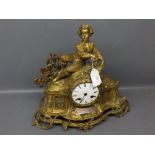 French brass mantel clock with heavily cast detail, seated gent to top with enamelled Arabic chapter