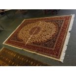 @Modern Keshan carpet, with cream and rust ground with floral design with central cream lozenge, 280