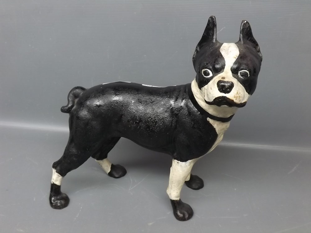 Cast iron metal model possibly of a pug, decorated in black and white with ears raised, 11 ins