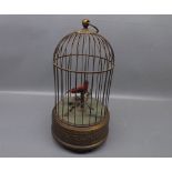 Mid-20th century brass framed automaton bird cage with single rotating "singing" bird, 10 1/2 ins