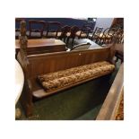 19th century oak church pew with single planked seat and panelled back, shaped ends, heavily