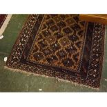 Bokhara style carpet with brown ground with geometric designed repeating centre among multi gulled