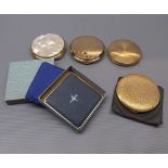 Five assorted powder compacts