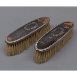 Pair of early 20th century silver and inlaid tortoiseshell backed clothes brushes, 6 1/2 ins long (