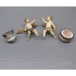 Mixed Lot: two porcelain painted models of putti, (one A/F), together with a further Victorian cat's