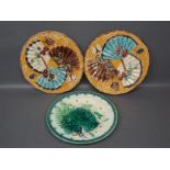 Pair of Majolica yellow ground plates with raised fan and floral relief, together with one further