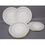 Group of eight Minton bone china plates, white ground with blue and gilt foliate edges, two 6 1/4