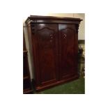 Late 19th century mahogany two door wardrobe, the detachable pediment with overhanging cornice to