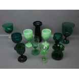 Two pressed glass pale green pedestal drinking glasses, various other green drinking glasses,