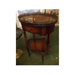 Modern oval occasional table with galleried top with fitted single drawer with further shelf on