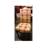 Modern upholstered side chair with yellow and red floral checked fabric on a shaped back and