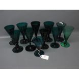 Collection of eleven various green glass conical wine glasses, all approx 5 1/2 ins high