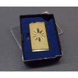 Brass and chromium cased stylised lighter by Kigu of London, with starburst style engraving, 2ins