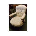 Late 19th century upholstered nursing chair with button back and upholstered arms on stuff-over seat