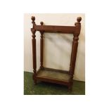 Late 19th/early 20th century oak framed stick stand with ring turned supports and 'H' framework to a