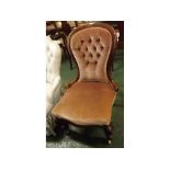 Victorian mahogany balloon-back nursing chair with puce upholstered seat and button back, on