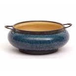 Linthorpe Pottery compressed circular two-handled dish applied with a base metal rim and handles,