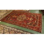 Caucasian wool carpet with mainly red field, with cream central floral lozenge with floral
