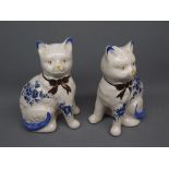 Pair of reproduction Staffordshire seated models of cats with bow-ties and blue floral decoration,