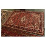 Modern Caucasian red ground carpet with central cream diamond lozenge with geometric floral
