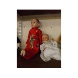 Oriental composition doll and a further AM baby doll