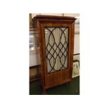 Continental cupboard with moulded overhanging cornice to a single glazed door with pleated curtain