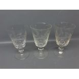 Pair of clear glass goblets with engraved barley detail, together with a further non-matching goblet
