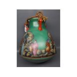 Green glass three-handled water vase with decorative printed scenes of water carriers, with