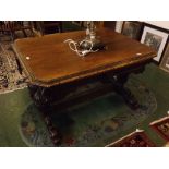 19th century oak Gothic side table, with heavily carved decoration on pineapple supports with wyvern