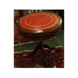 Reproduction small drum table with red leather and tooled insert on a turned column on a