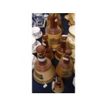Seven Wade Bells Scotch Whiskey containers, of various sizes, largest 10ins