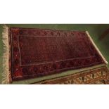 Modern Bokhara style carpet with mainly red and blue ground, with repeating lozenge detail and