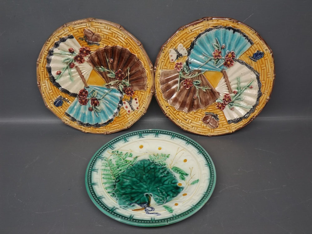 Pair of Majolica yellow ground plates with raised fan and floral relief, together with one further