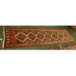 Caucasian red and blue ground floor runner with repeating lozenge centre, 29 x 117ins