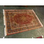 Caucasian red ground carpet with central floral lozenge and multi gull border, 49 x 69ins