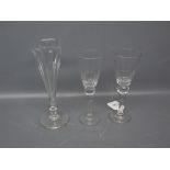 Two clear glass thistle style wine glasses; and a further champagne flute with half-fluted
