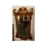 Large walnut Chippendale style parcel gilded wall mirror, of rectangular form, decorated with "C"