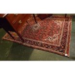 Modern Caucasian red ground carpet with central cream diamond lozenge with geometric floral