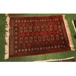 Modern Caucasian wool rug, decorated in the Bokhara manner with triple gull border, central panel of