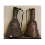 Two African copper water carriers of tapering cylindrical form with ribbed neck and applied side