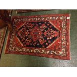 Small Caucasian wool prayer rug, central lozenge, mainly puce and blue field, 45 x 32 ins