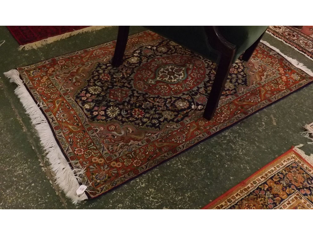 Modern wool and cotton rug, with floral and bird rust coloured border to a central lozenge with dark