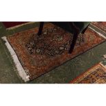 Modern wool and cotton rug, with floral and bird rust coloured border to a central lozenge with dark