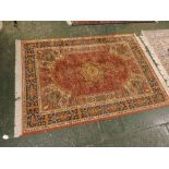 Caucasian red ground carpet with central floral lozenge and multi gull border, 49 x 69ins