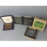 Box containing six early 20th century glass lantern slides depicting early motorcycling scenes, each