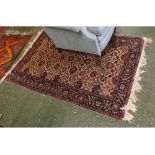 Persian style wool rug with floral patterned centre, in red, blue and beige, 5ft 8ins x 3ft 10ins