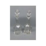 Pair of early 20th century clear glass mallet formed decanters with matching stoppers, each 13ins