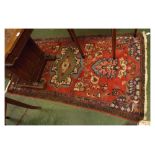 Caucasian red ground wool wash rug with geometric designs, 43ins x 77ins